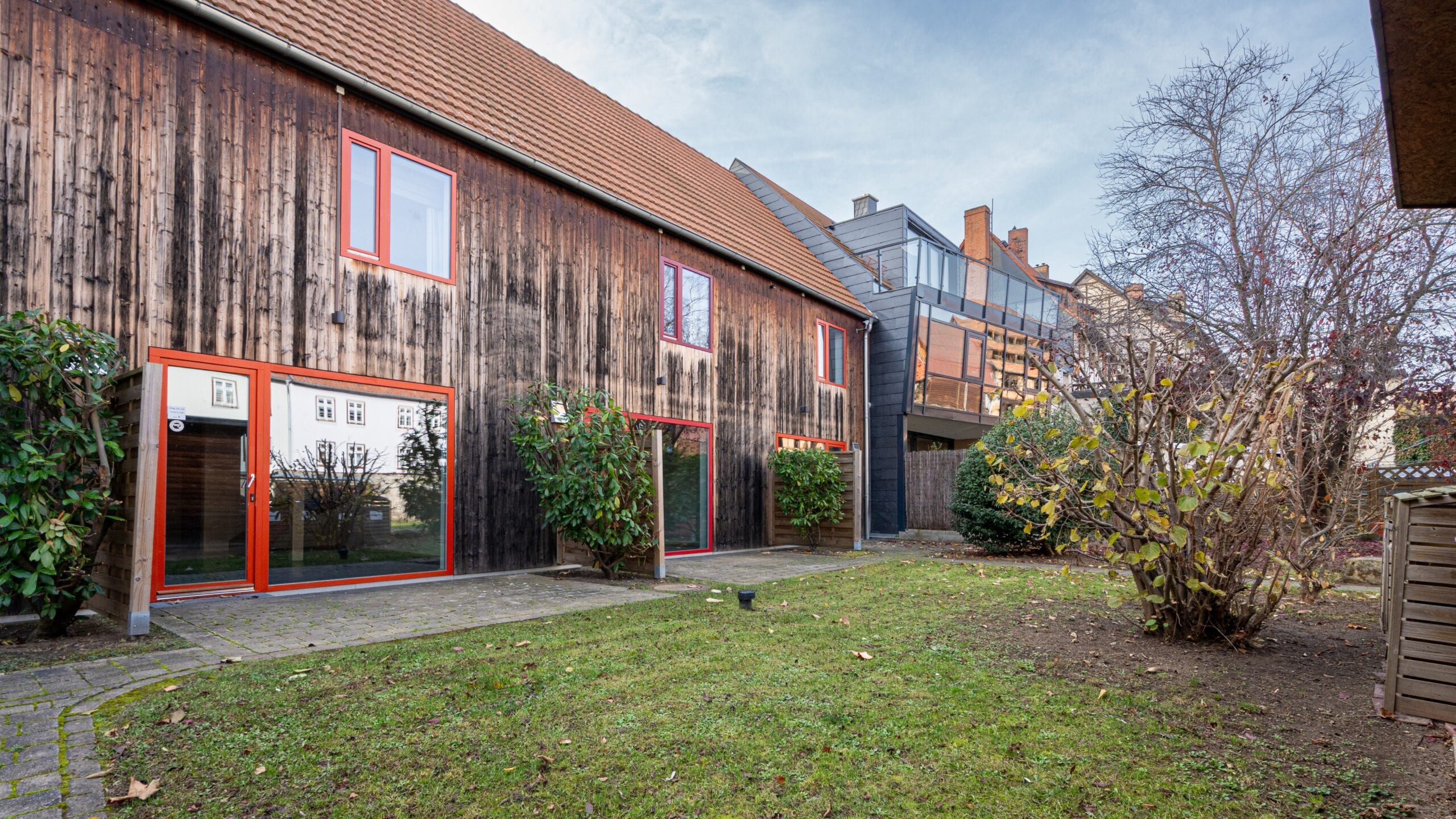 Holzhaus mit Garten und Büschen